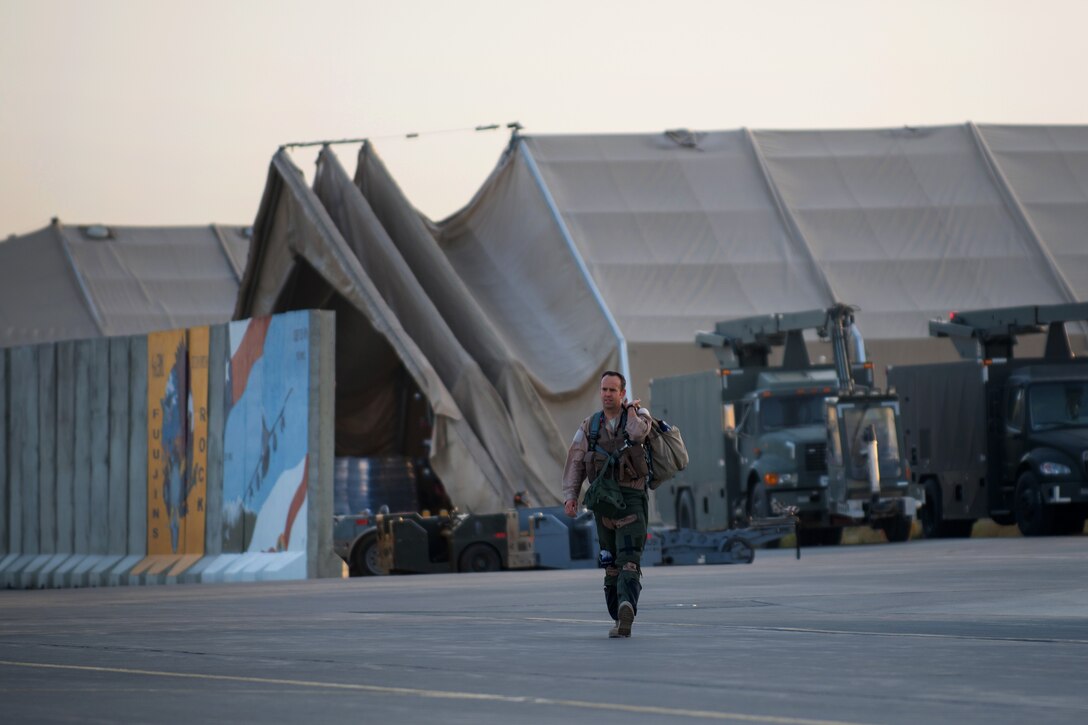 A U.S. Air Force F-16 Fighting Falcon pilot walks to an aircraft on Bagram Airfield, Afghanistan, Sept. 15, 2015. U.S. Air Force photo by Tech. Sgt. Joseph Swafford