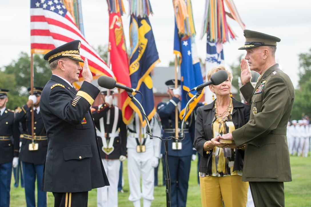 Army Gen. Martin E. Dempsey, left, 18th chairman of the Joint Chiefs of Staff, swears in his predecessor, Marine Corps Gen. Joseph F. Dunford Jr., during a ceremony on Joint Base Myer-Henderson Hall in Arlington, Va., Sept. 25, 2015. DoD photo by D. Myles Cullen