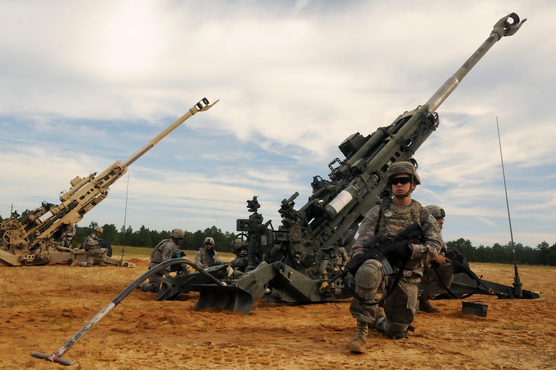 A soldier provides security for his M777A2 Medium howitzer during the Division Artillery Readiness Test on Fort Bragg, N.C., Sept. 18, 2015. The soldier is an artilleryman assigned to the 82nd Airborne Division, 2nd Battalion, 319th Airborne Field Artillery Regiment. U.S. Army photo by Capt. Joe Bush