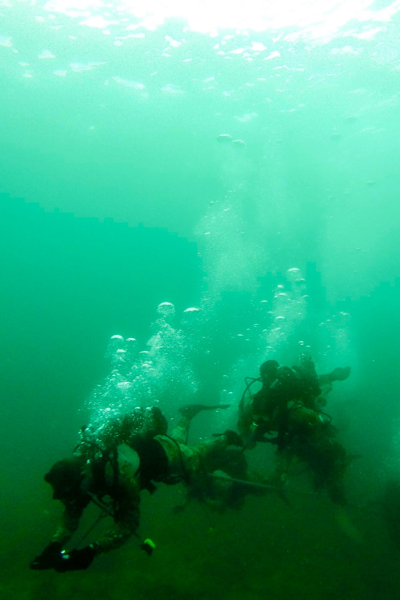 Combat control Airmen from the 320th Special Tactics Squadron at Kadena Air Base, Japan, perform an open-circuit navigation dive during an amphibious operations exercise Sept. 22, 2015, off the West Coast of Okinawa, Japan. Special tactics team Airmen are organized, trained and equipped to conduct special operations core tasks during high-risk combat operations. (Courtesy photo)