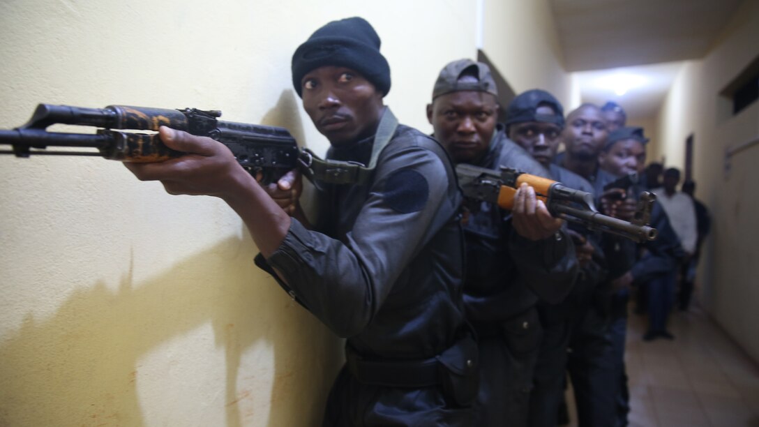 Benin National Surveillance Police students prepare to enter a room during an early morning raid exercise at Benin's Military Officer Academy in Toffo, Benin, Sept. 25, 2015. More than 150 National Surveillance Police students graduated from a monthlong U.S. Marine Corps training evolution that included weapons handling, combat marksmanship, patrolling, close-quarters combat, tactical site exploitation, tactical questioning and the operations order process.