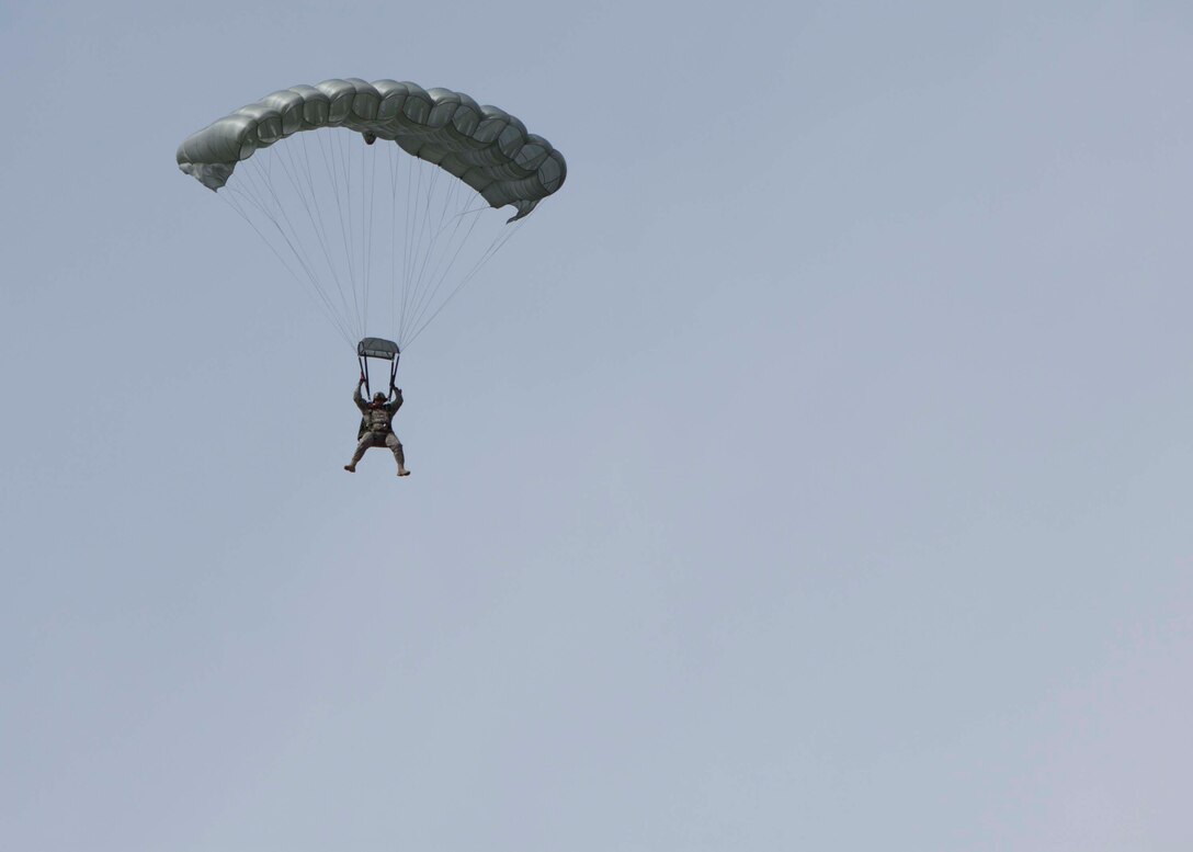 Army Staff Sgt. Jay Media, operations non-commissioned officer in charge, parachutes to the ground during a free fall jump on April 14.