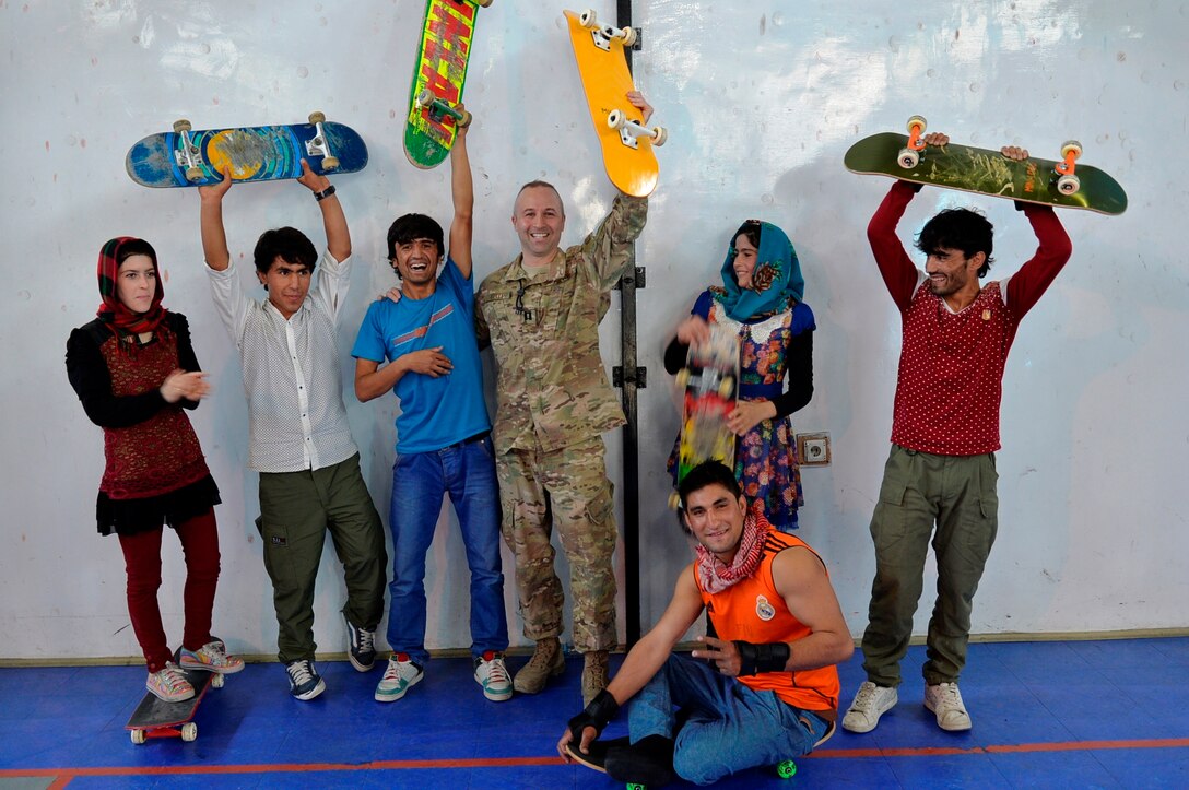 Capt. Jeffery Kelly, chief of the 442d Fighter Wing’s Public Affairs Office, spends time with some of the Afghan youth who have benefitted from his charity work while he’s deployed to Kabul, Afghanistan. Kelly earned a master of science in Kinesiology degree from Georgia Southern University and understands the physiological, mechanical, and psychological benefits of giving Afghan youth constructive physical activity (photo submitted by Capt. Jeffery Kelly)