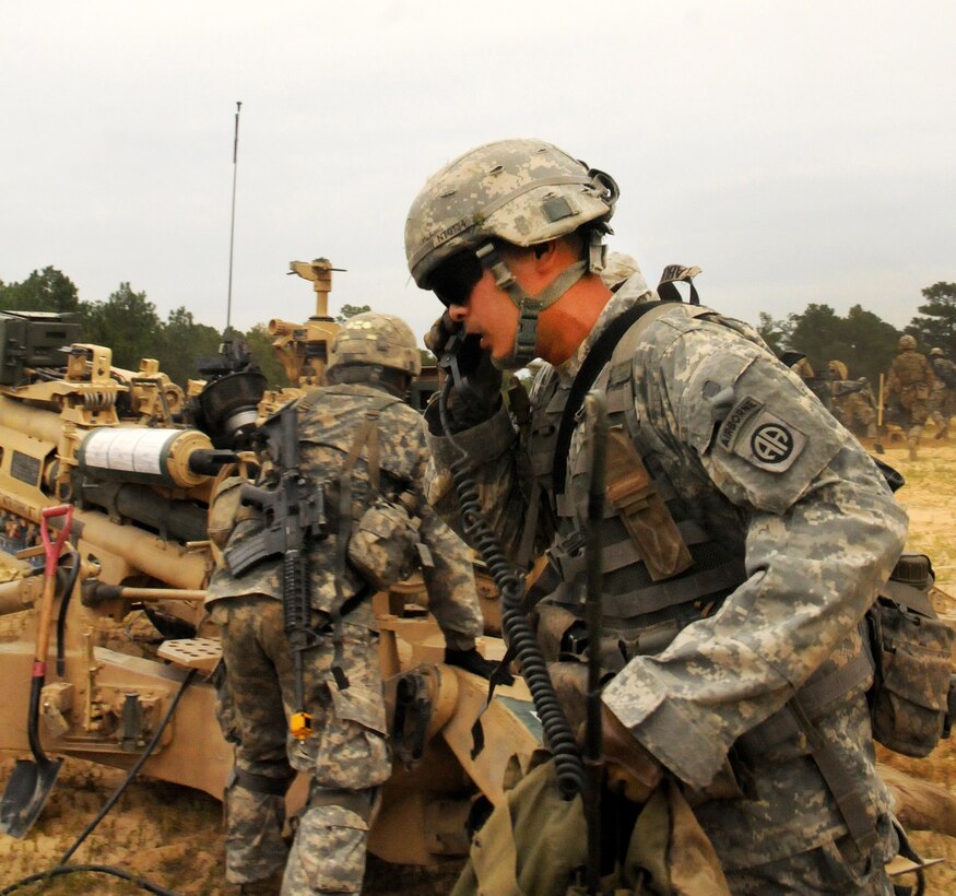 A soldier attempts to gain communication with the platoon fire direction center in order to receive fire missions while the rest of his crew rapidly emplaces their M777A2 howitzer during the Division Artillery Readiness Test on Fort Bragg, N.C., Sept. 18, 2015. The soldier is a radio and telephone operator assigned to the 82nd Airborne Division, 2nd Battalion, 319th Airborne Field Artillery Regiment. U.S. Army photo by Capt. Joe Bush