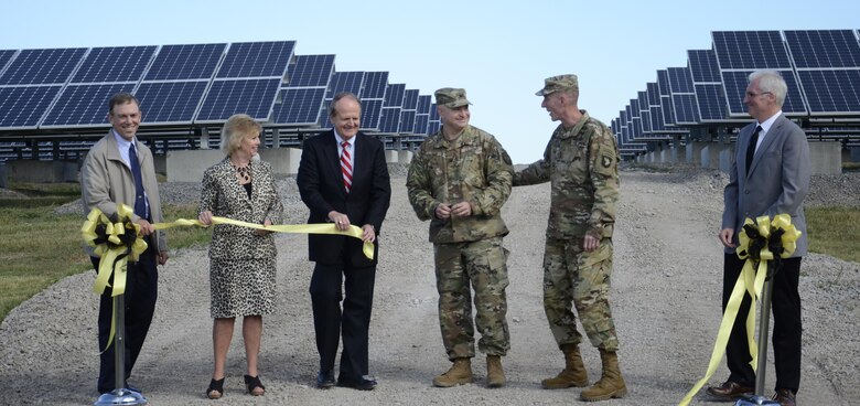 Jim Duttweiler, Directorate of Public Works, Sandy Grogan, Pennyrile Rural Electric Cooperative, John Davies, Kentucky Department for Energy Development and Independence, and Rick McCoy, DPW, join Garrison Commander Col. James “Rob” Salome and Maj. Gen. Gary J. Volesky, 101st Airborne Division and Fort Campbell commander, for the ribbon-cutting for Phase One of the installation’s solar array.