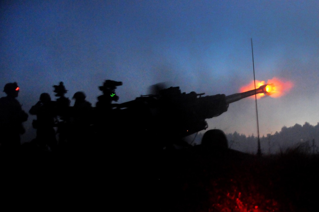 An M777A2 howitzer crew fires its 155mm cannon in the early morning hours as part of a battery time on target mission during the Division Artillery Readiness Test on Fort Bragg, N.C., Sept. 18, 2015. U.S. Army photo by Capt. Joe Bush