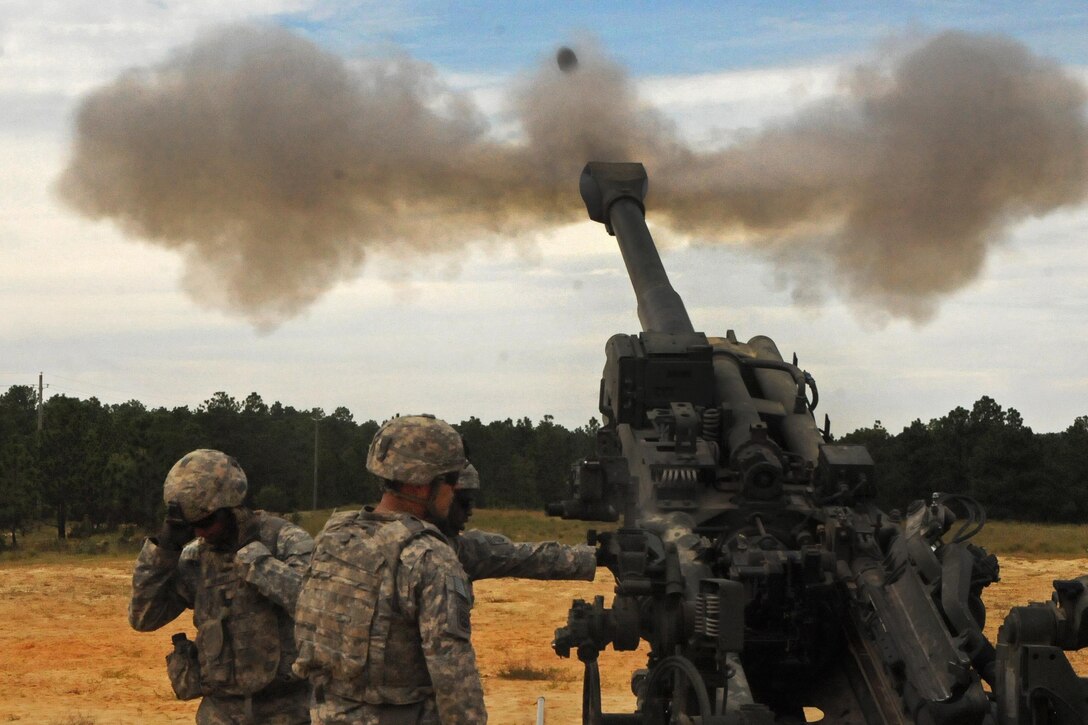 An M777A2 howitzer crew fires its 155mm cannon during an artillery readiness test on Fort Bragg, N.C., Sept. 18, 2015. U.S. Army photo by Capt. Joe Bush
