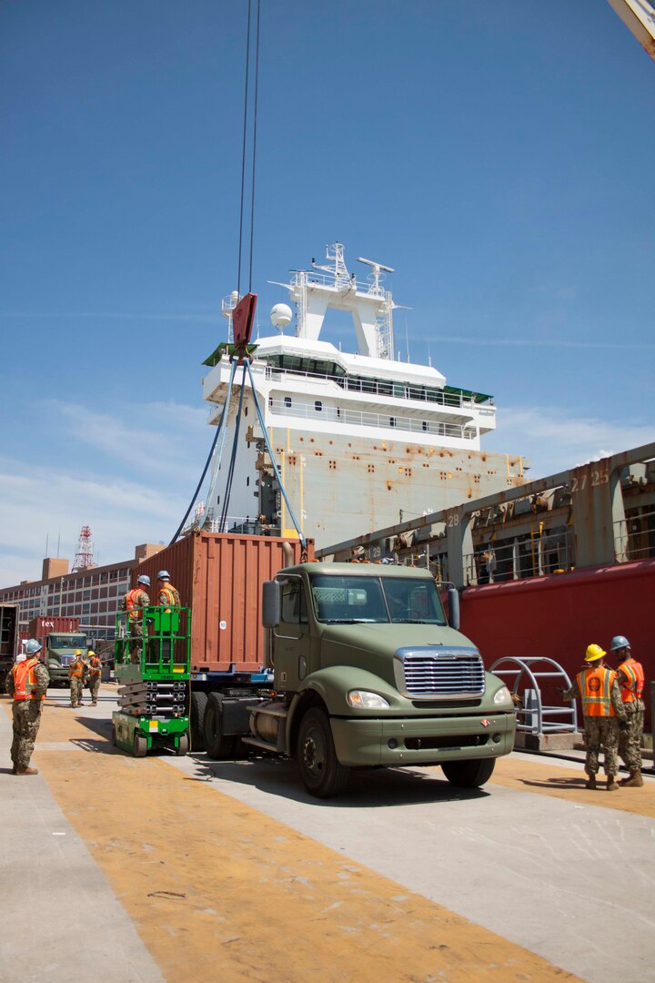 Stevedores assist with loading a container onto the Ocean Giant.