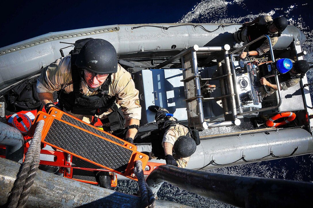 Navy Ensign Thomas Schofer disembarks a rigid-hull inflatable boat to climb aboard the amphibious transport dock ship USS New Orleans after completing a visit, board, search and seizure training exercise in the Pacific Ocean, Sept. 25, 2015. The ship is preparing for its upcoming deployment. U.S. Navy photo by Petty Officer 1st Class Gary Granger Jr.
