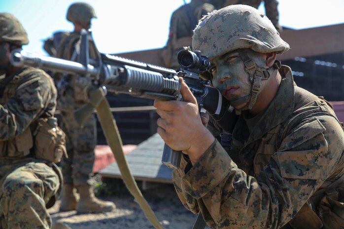 Private First Class Mason A. Davis, Charlie Company, 1st Recruit Training Battalion, provides security while his fire team works its way through one of the 12 challenging obstacles during the 12 Stalls event at Edson Range, Marine Corps Base Camp Pendleton, Sept. 23. The stalls, which stand approximately 20 feet wide and 20 feet deep, are set up in three columns. After receiving only a small set of tools and basic instructions for each station, the fire team was quickly on its way to complete each mission. The instructions described their task to be completed as well as guidelines they must follow to successfully complete the challenge. Today, all males recruited from west of the Mississippi are trained at MCRD San Diego. The depot is responsible for training more than 16,000 recruits annually. Charlie Company will graduate Oct. 2.