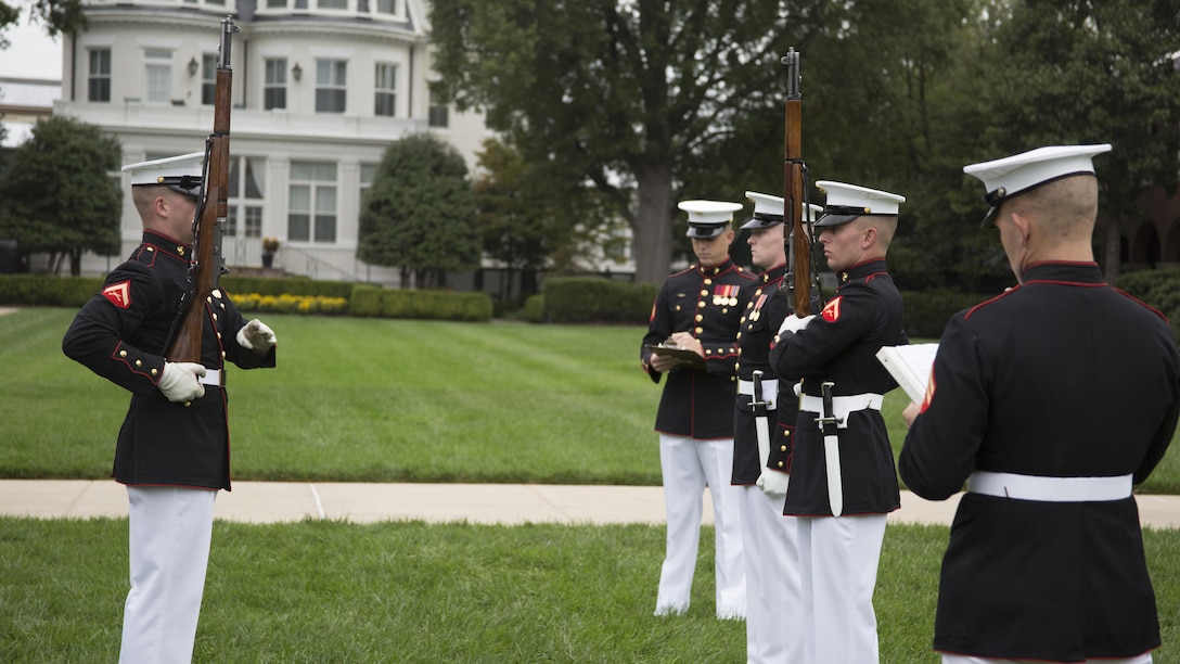 Members of the Silent Drill Platoon perform their routines while being evaluated during Challenge Day at Marine Barracks Washington, D.C., Sept. 22, 2015. Each Marine performs the scripted throws, spins and drill movements while evaluators take notes on clipboards and silently score the competitors. A recommendation will be provided to the Barracks’ commanding officer and Sgt. Maj., and they will make the ultimate decision on the 2016 rifle inspection team.(U.S. Marine Corps photo by Cpl. Skye Davis/Released)
