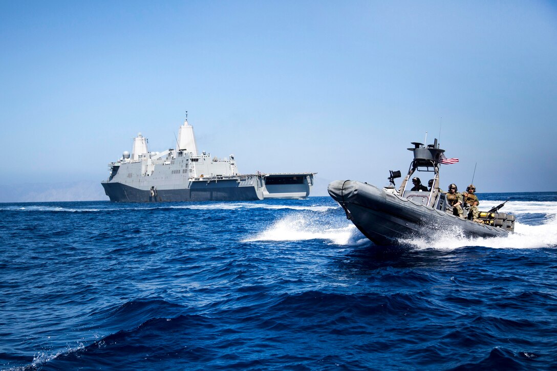 Marines and sailors ride in a rigid hull inflatable boat from the USS New Orleans to conduct a visit, board, search and seizure aboard a simulated enemy vessel during an exercise off the coast of San Clemente Island, Calif., Sept. 23, 2015. The Marines and sailors are assigned to Maritime Raid Force, 13th Marine Expeditionary Unit, 1st Marine Expeditionary Force. U.S. Marine Corps photo by Sgt. Tyler C. Gregory