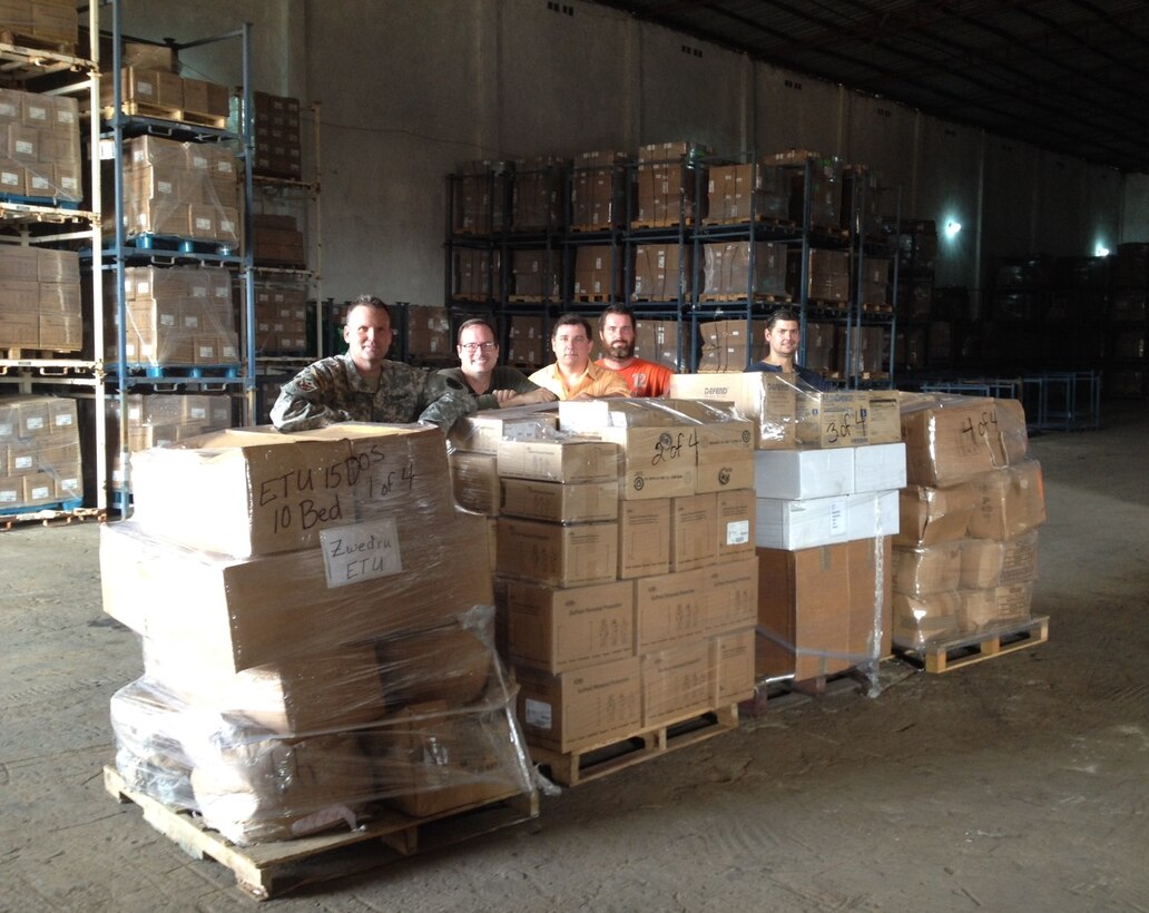 Pete Todd, second from left, and other members of the DLA Distribution Expeditionary Team and a member of DLA Troop Support Medical, pose with supplies in West Africa. 