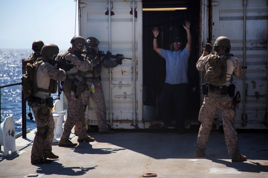 Marines simulate detaining passengers while conducting a visit, board, search and seizure during the PHIBRON-MEU integration exercise off the coast of San Clemente Island, Ca., Sept. 23, 2015. U.S. Marine Corps photo by Sgt. Tyler C. Gregory