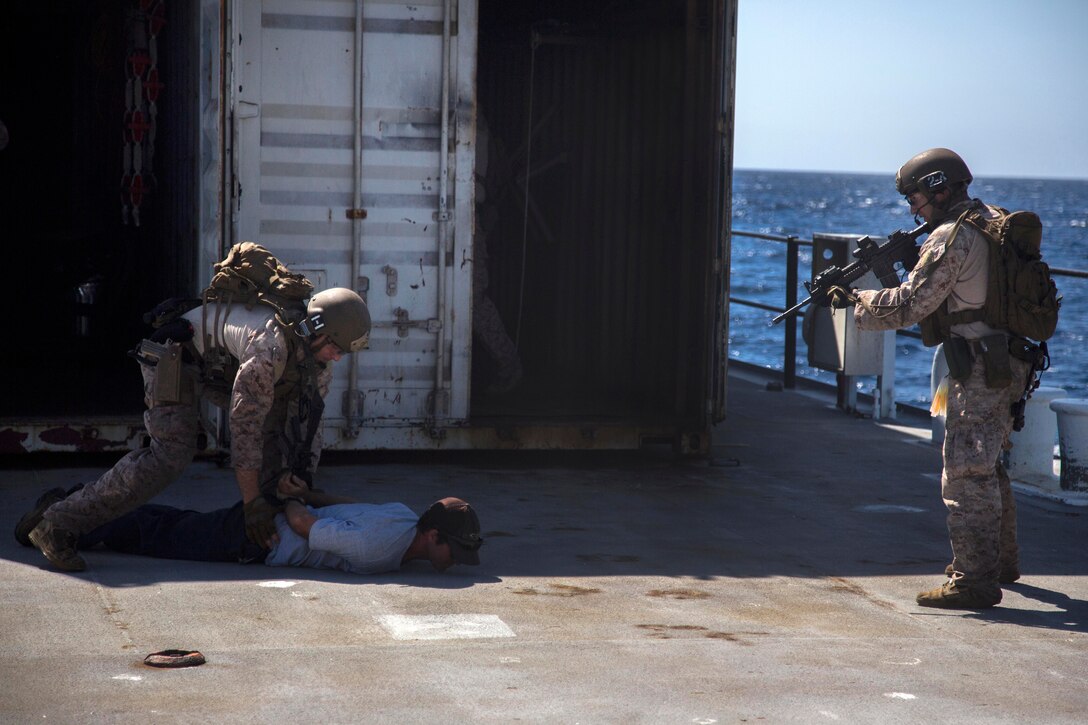 Marines simulate detaining passengers while conducting a visit, board, search and seizure during the PHIBRON-MEU integration exercise off the coast of San Clemente Island, Ca., Sept. 23, 2015. U.S. Marine Corps photo by Sgt. Tyler C. Gregory