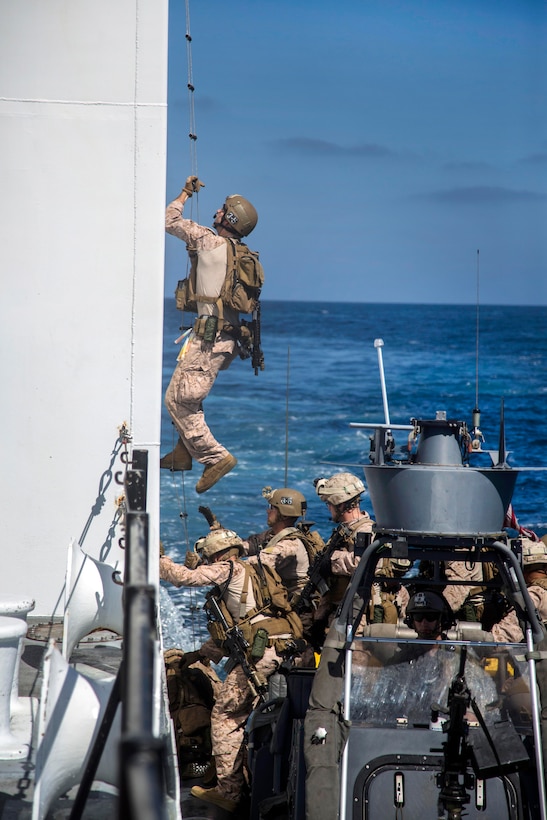 Marines board a simulated enemy vessel utilizing a caving ladder while conducting a visit, board, search and seizure aboard a simulated enemy vessel during an exercise off the coast of San Clemente Island, Calif., Sept. 23, 2015. U.S. Marine Corps photo by Sgt. Tyler C. Gregory 