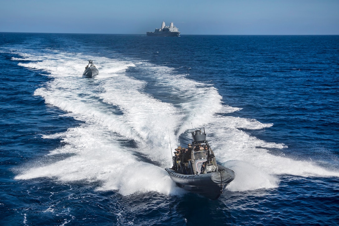 Marines and sailors ride in a rigid hull inflatable boat from the USS New Orleans to conduct a visit, board, search and seizure aboard a simulated enemy vessel during an exercise off the coast of San Clemente Island, Calif., Sept. 23, 2015. U.S. Marine Corps photo by Sgt. Tyler C. Gregory