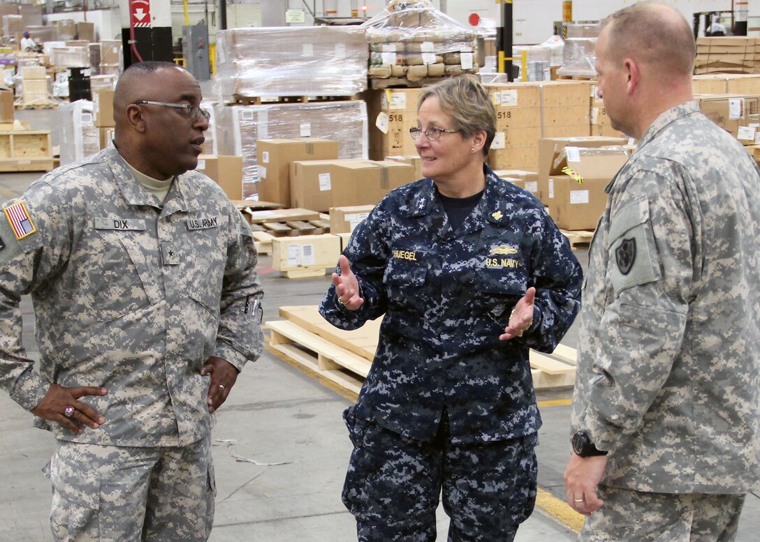 Navy Rear Adm. Valerie K. Huegel, incoming commander to U.S. Central Command’s Deployment Distribution Operations Center in Kuwait, tours DLA Distribution Susquehanna, Pa.’s Eastern Distribution Center alongside DLA Distribution commander Army Brig. Gen. Richard Dix, left, and DLA Distribution Susquehanna, Pa., commander Col. Corey New.  