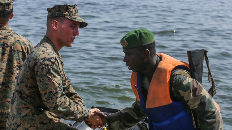 U.S. Marine Lance Cpl. Austin Carpenter, a rifleman, shakes his counterpart Compagnie Fusilier de Marin Commando’s hand after successfully completing the final exercise with U.S. service members in Dakar, Senegal, Sept. 17, 2015. The Marines and Coast Guardsmen with Special-Purpose Marine Air-Ground Task Force Crisis Response-Africa spent four weeks training the COFUMACO on basic infantry tactics and small-boat operations as a part of a Maritime Security Force Assistance mission to increase interoperability with Senegal’s and strengthen the bond between the partner nations. 