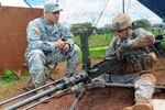 Sgt. Matthew Gallaway (right), an infantryman with Company A, 1st battalion, 27th Infantry Regiment, 2nd Stryker Brigade Combat Team, 25th Infantry Division, performs a functions check on a .50 caliber machine gun, Sept. 16, while graded by Staff Sgt. Johnathan Sablan (left), an infantryman with Company A, 1-27 IR, during the Expert Infantry Competition. Fifty Soldiers who competed in this iteration of the EIB competition earned the coveted badge. 