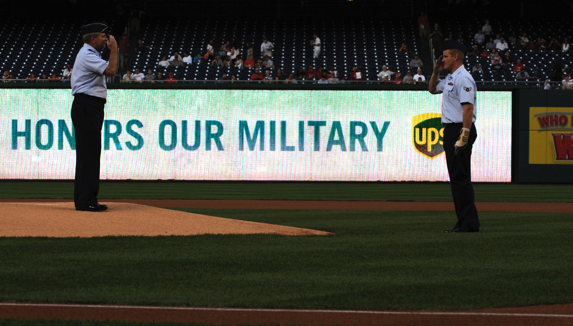 Airman 1st Class Spencer Stone, an Airman's Medal and Purple Heart recipient, relieves Air Force Chief of Staff Gen. Mark A. Welsh III from the pitcher's mound at Nationals Park in Washington, D.C., Sept. 18, 2015. Stone was called to throw the first pitch of the game between the Washington Nationals and the Miami Marlins. (U.S. Air Force photo/Senior Airman Hailey Haux)