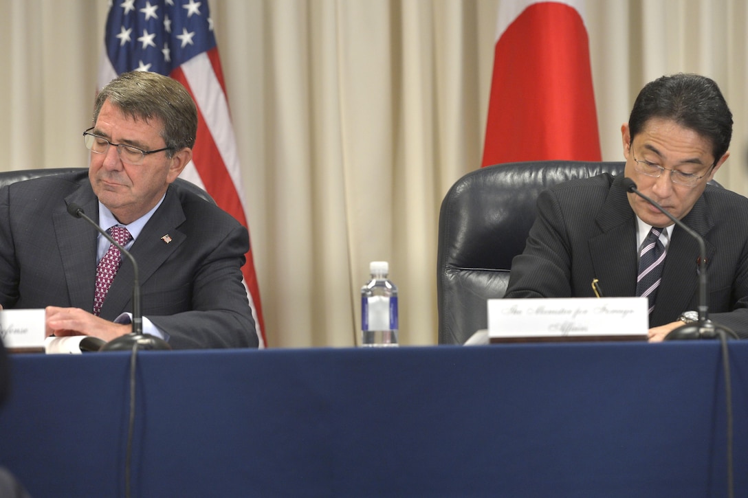 U.S. Defense Secretary Ash Carter and Japanese Foreign Minister Fumio Kishida sign an agreement during a ceremony at the Pentagon, Sept. 28, 2015. The agreement is a clarification on environmental stewardship related to U.S. forces in Japan. DoD photo by Glenn Fawcett