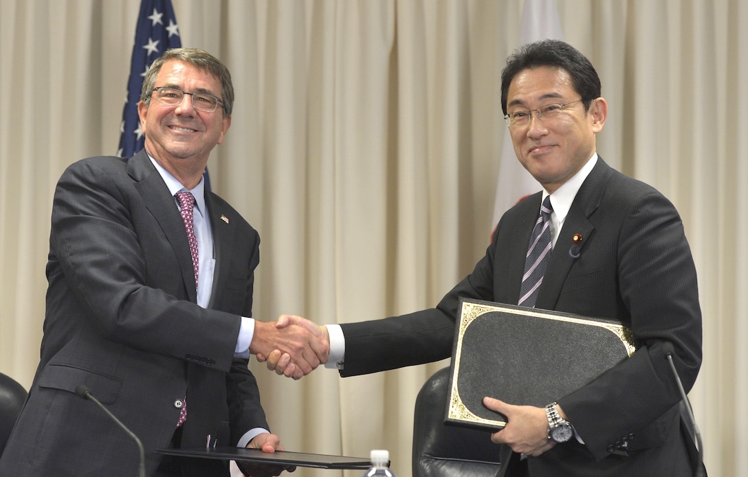 U.S. Defense Secretary Ash Carter shakes hands with Japanese Foreign Minister Fumio Kishida after signing an agreement during a ceremony at the Pentagon, Sept. 28, 2015. DoD photo by Glenn Fawcett