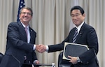 Secretary of Defense Ash Carter shakes hands with Japan's Minister for Foreign Affairs Fumio Kishida after signing the "Agreement to Supplement the Japan-U.S. Status of Forces Agreement (SOFA) on Environmental Stewardship” during a signing ceremony at the Pentagon.  