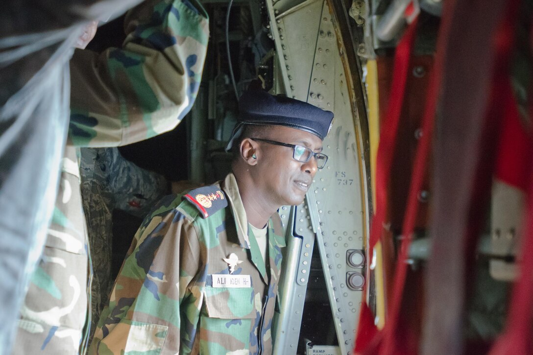 A Djiboutian service member looks out from an aircraft while visiting the Kentucky Air National Guard Base in Louisville, Ky., Sept. 17, 2015. During the visit, Djiboutian service members toured base facilities, attended mission briefings and flew on a local training sortie aboard a Kentucky Air National Guard C-130 Hercules aircraft. Kentucky National Guard photo by Air Force Master Sgt. Phil Speck