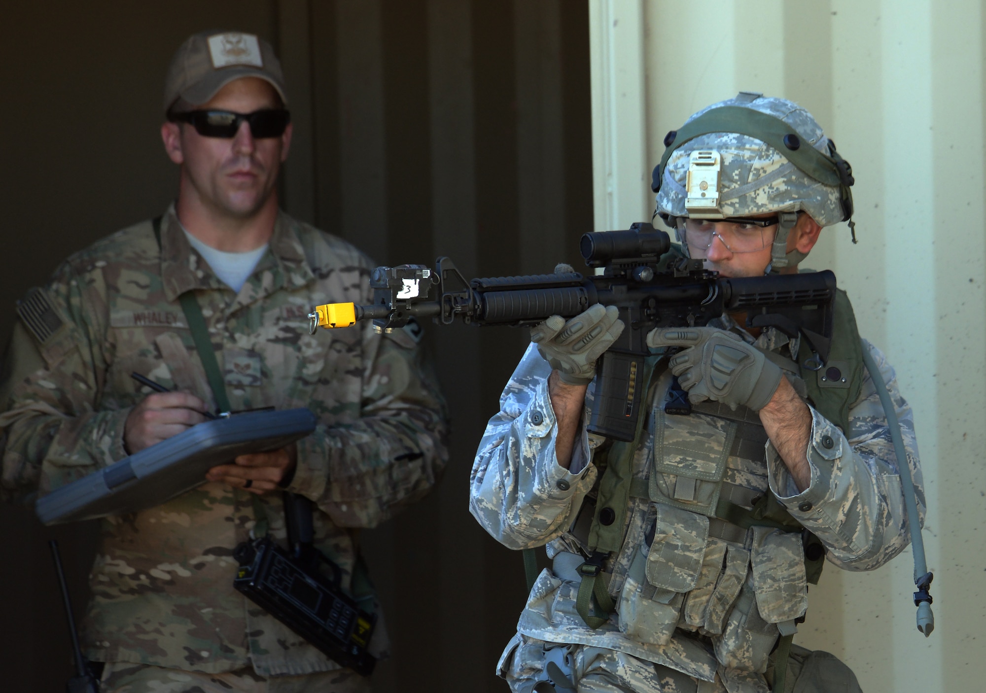Staff Sgt. James Finley, 7th Bomb Wing, Dyess Air Force Base, Texas, scans an area while Staff Sgt. Steven Whaley, 620th Ground Combat Training Squadron instructor, Camp Guernsey, Wyo., evaluates his tactics during the tactical recapture portion of the 2015 Global Strike Challenge security forces competition on Camp Guernsey, Wyo., Sept. 24, 2015. Teams were evaluated on their tactics including use of cover, building clearing procedures and team communication. (U.S. Air Force photo by Senior Airman Brandon Valle) 