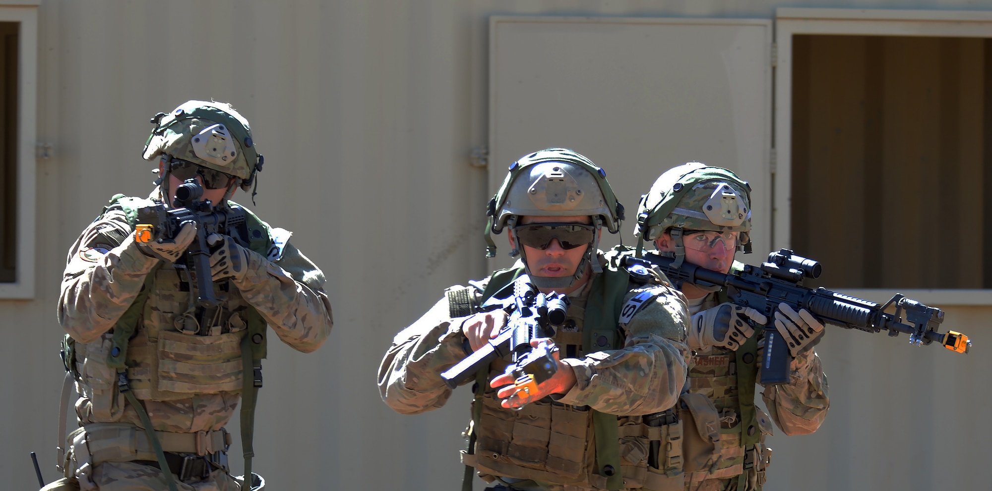 Airman 1st Class Riley Burges, Senior Airman Christian McGinnis, and 2nt Lt. Michael Thrasher, 90th Missile Wing, F.E. Warren Air Force Base, Wyo., move as a group towards a building Sept. 24, 2015, during the tactical recapture portion of the 2015 Global Strike Challenge security forces competition on Camp Guernsey, Wyo. Teams relied on each other as they moved from building to building in order to watch for opposing forces and potential targets. (U.S. Air Force photo by Senior Airman Brandon Valle)