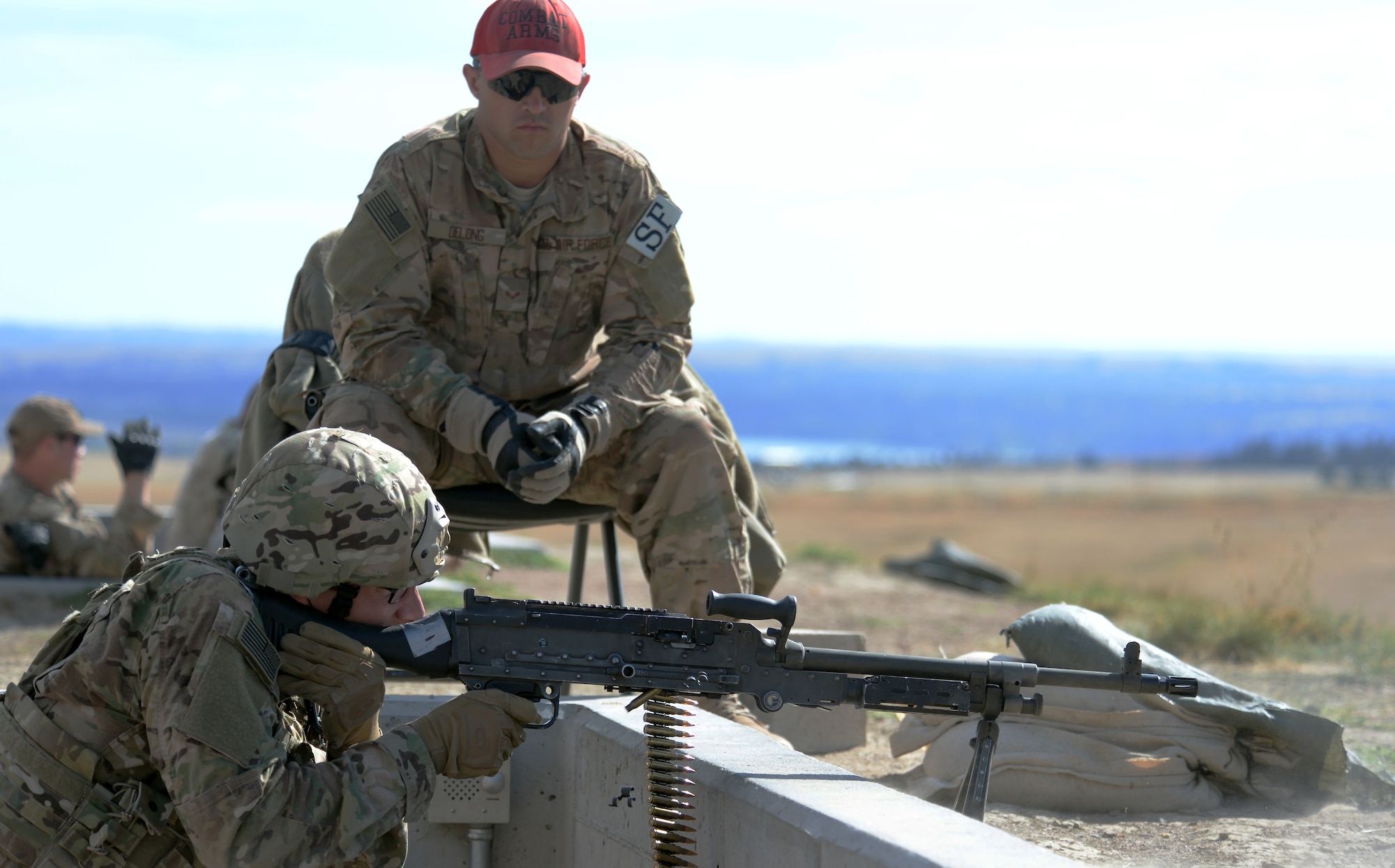 Staff Sgt. Richard Trimble, 90th Missile Wing, F.E. Warren Air Force Base, Wyo., fires an M-240 machine gun at a set of targets while Senior Airman Jeff Delong, 620th Ground Combat Training Squadron instructor, observes him Sept. 23, 2015, during a shooting portion of the 2015 Global Strike Challenge security forces competition on Camp Guernsey, Wyo. Ten security forces teams from eight Global Strike Command bases are competing to determine which base trains the best of the best. (U.S. Air Force photo by Senior Airman Brandon Valle)
