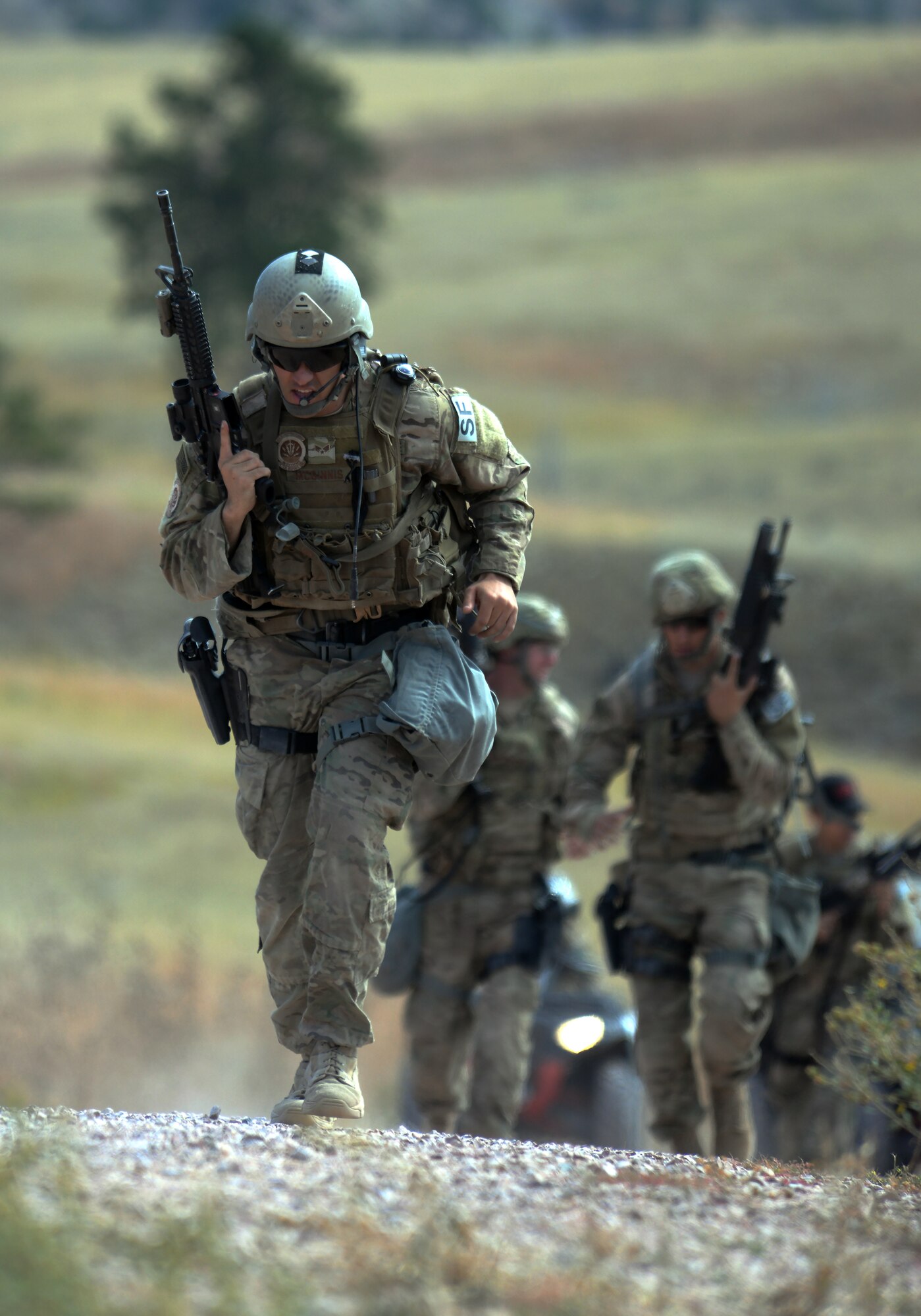 Senior Airman Christian McGinnis, 90th Missile Wing, F.E. Warren Air Force Base, Wyo., leads his team up a hill between two shooting ranges Sept. 23, 2015, during the shooting range portion of the 2015 Global Strike Challenge security forces competition on Camp Guernsey, Wyo. Each portion of the GSC is designed to test security forces Airmen on day-to-day skills as well as pushing them physically. (U.S. Air Force photo by Senior Airman Brandon Valle)