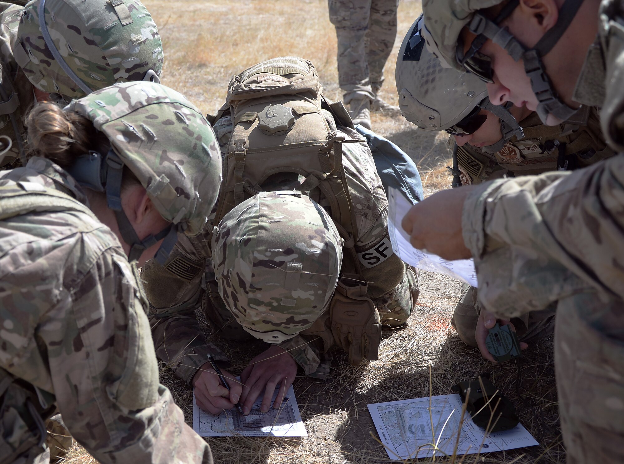 The F.E. Warren Air Force Base, Wyo.'s, 2015 Air Force Global Strike Command team plots coordinates on a map during the land navigation portion of the 2015 Global Strike Challenge security forces competition on Camp Guernsey, Wyo., Sept. 22, 2015. Teams had to work together to find exact locations on a map and then navigate to them in Camp Guernsey's north training area. (U.S. Air Force photo by Senior Airman Brandon Valle)