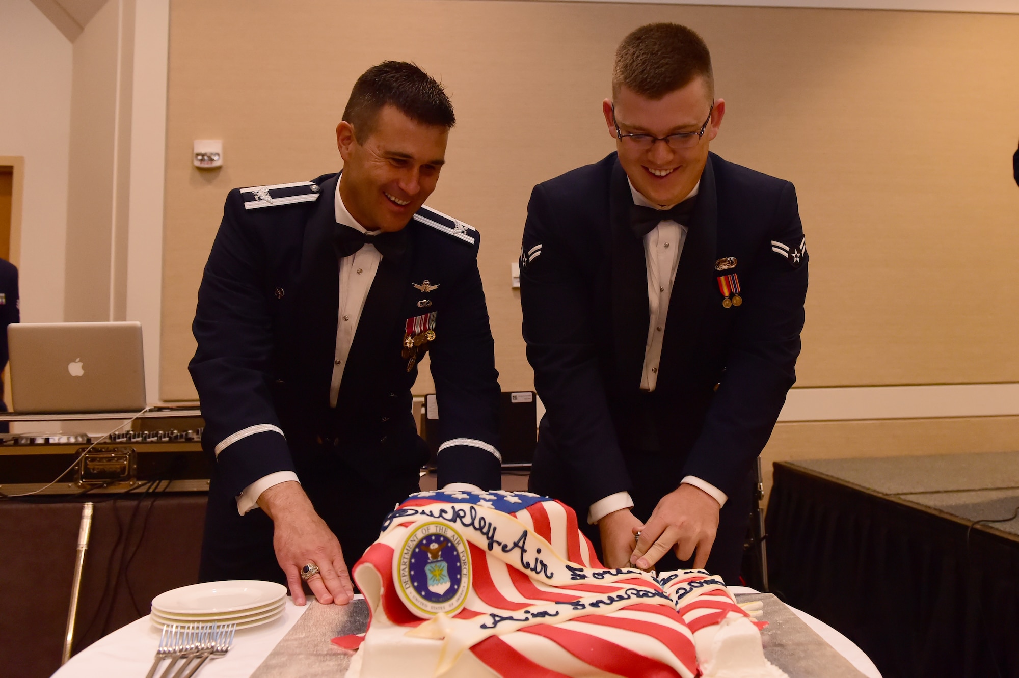 Col. John Wagner, 460th Space Wing commander and Airman 1st Class Don Cox, Force Support Squadron customer support technician, cut the cake at the Air Force Ball Sept. 25, 2015, at the Westin Hotel in Denver. Team Buckley held an annual ball to celebrate the 68th birthday of the Air Force. (U.S. Air Force photo by Airman 1st Class Luke W. Nowakowski/Released)