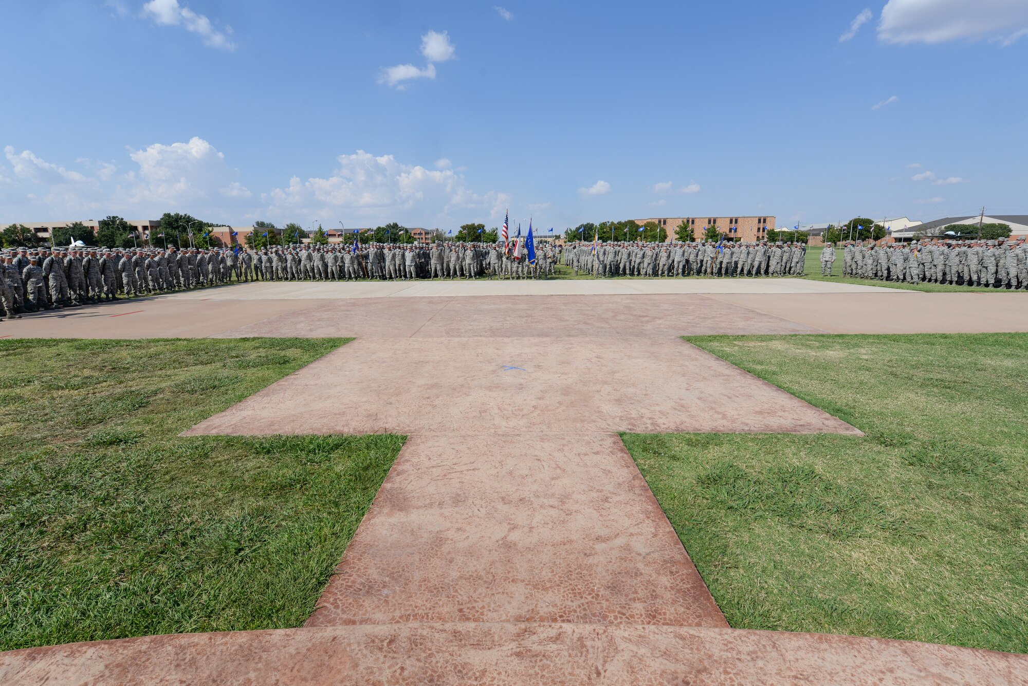 Technical training students at Sheppard Air Force Base, Texas, stand at parade rest before participating in a drill competition at the parade grounds, Sept. 25, 2015. Teams of Airmen from different training squadrons compete against each other for a drill master trophy. (U.S. Air Force photo/Senior Airman Kyle Gese)