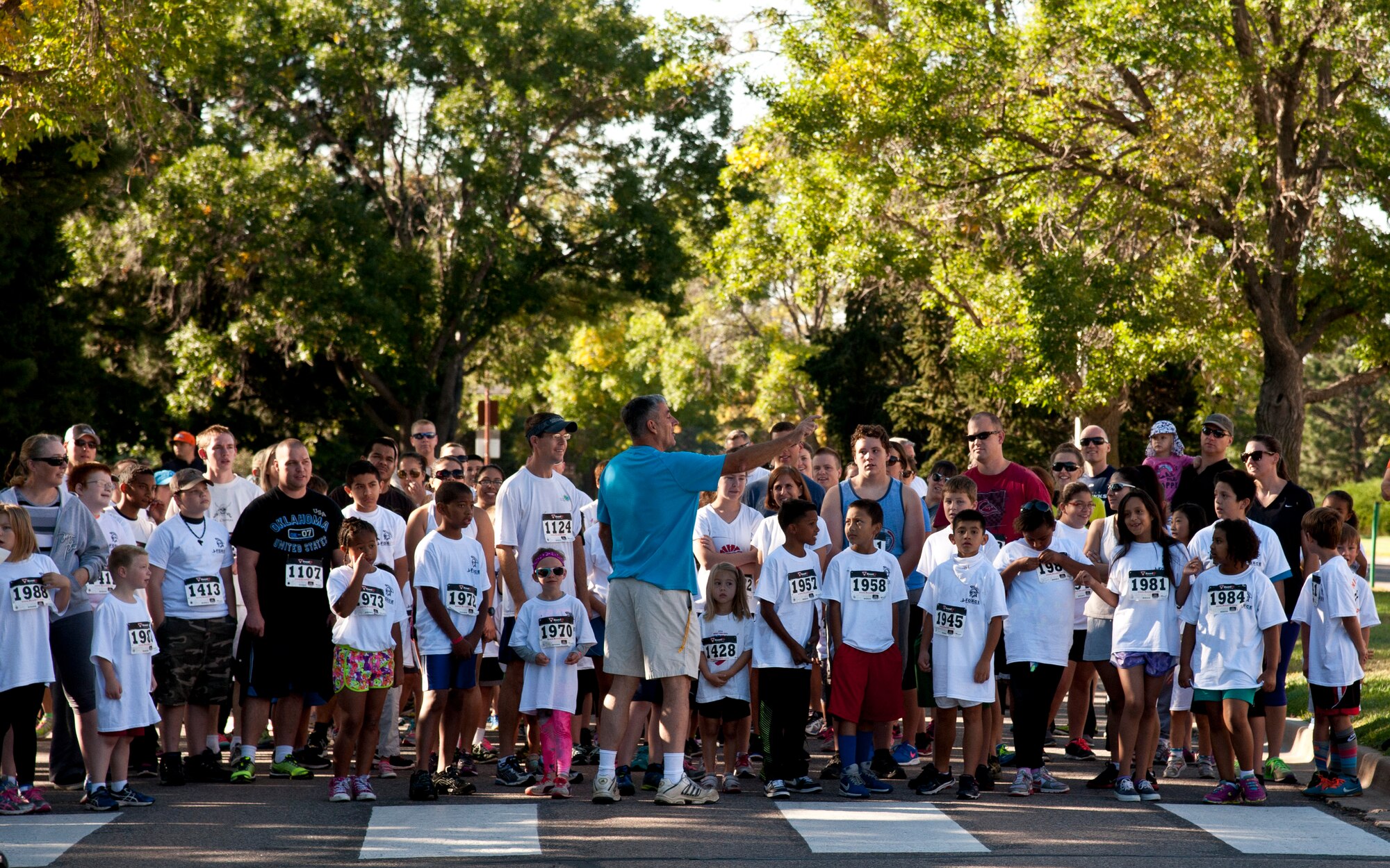 PETERSON AIR FORCE BASE, Colo. – Les Stewart, 21st Force Support Squadron special programs manager, explains the running route for the Color Run as part of the Worldwide Day of Play at Patriot Park, Sept. 26, 2015.  Nickelodeon’s annual event encouraged children to break away from technology and play outside. The event included inflatable obstacle courses, games, snacks and demonstrations from the Colorado National Guard, Peterson Fire fighters and Peterson Mobile Emergency Operations Center. (U.S. Air Force photo by Senior Airman Tiffany DeNault)