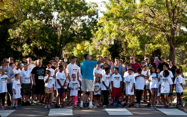 PETERSON AIR FORCE BASE, Colo. – Les Stewart, 21st Force Support Squadron special programs manager, explains the running route for the Color Run as part of the Worldwide Day of Play at Patriot Park, Sept. 26, 2015.  Nickelodeon’s annual event encouraged children to break away from technology and play outside. The event included inflatable obstacle courses, games, snacks and demonstrations from the Colorado National Guard, Peterson Fire fighters and Peterson Mobile Emergency Operations Center. (U.S. Air Force photo by Senior Airman Tiffany DeNault)
