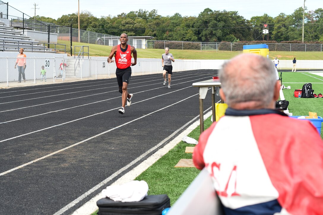 Frank Lathron, an 82-year-old senior olympian, watches his fellow competitors’ race in the 400-meter run during the Georgia Golden Olympics Sept. 17, 2015, in Warner Robins, Ga. Lathron sustained an injury during his first run of the day, but stayed to cheer on his fellow competitors. (U.S. Air Force photo by Senior Airman Ceaira Tinsley/ Released)