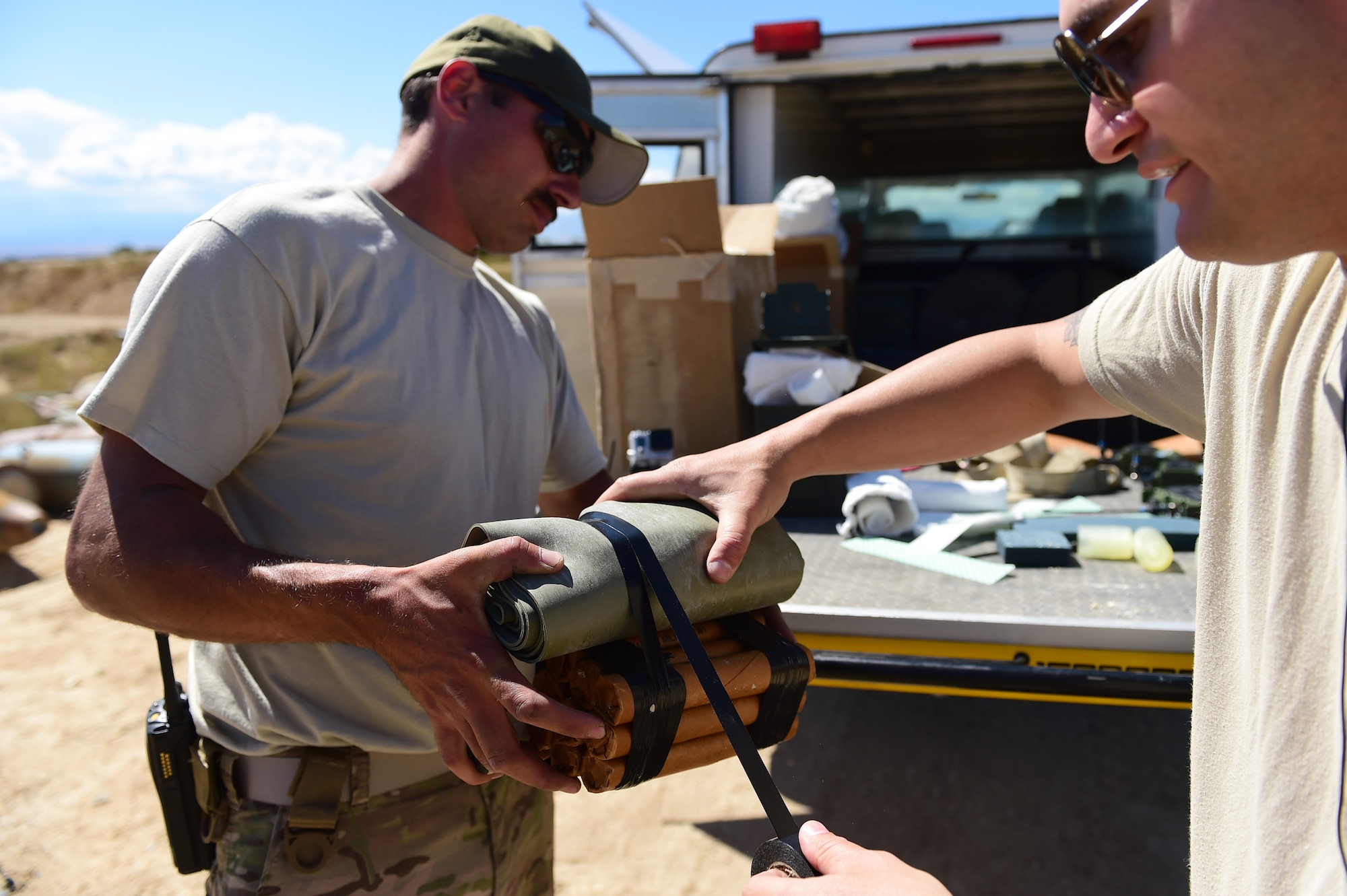 Staff Sgt. Darrel Linkus, 140th Explosive Ordnance Disposal operator, and Staff Sgt. Robert Rich, 140th EOD operator, prepare a clean-up shot Sept. 23, 2015, at Airburst Range, Colo. A clean-up shot is composed of explosives and is used to detonate any remnants of a prior explosion. (U.S. Air Force photo by Airman 1st Class Luke W. Nowakowski/Released)