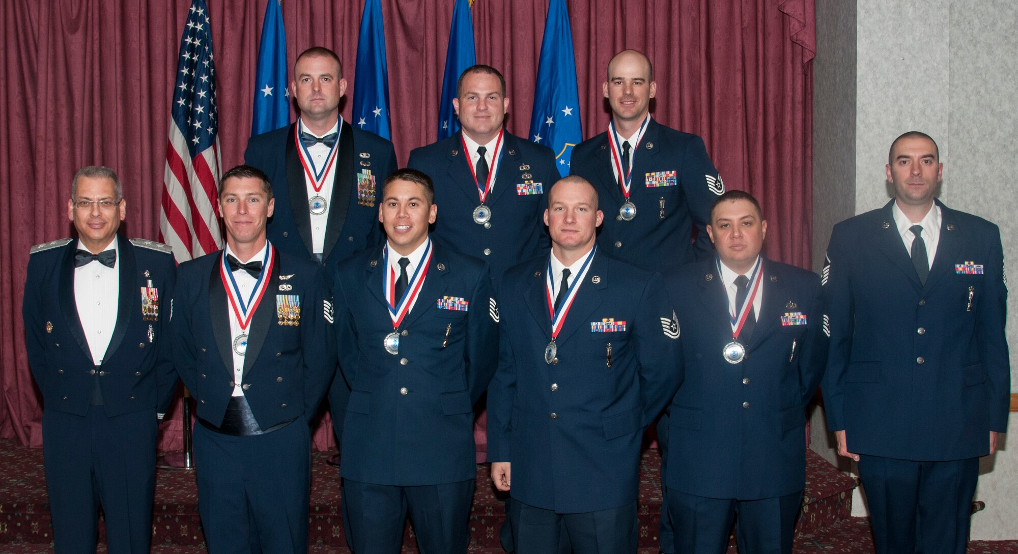 Maj. Gen. Jack Weinstein, 20th Air Force and Task Force 214 commander, and Master Sgt. Victor Jeancola, 20th Air Force missile maintenance manager, pose for a photo with the 20th Air Force/Task Force 214 Airmen the numbered air force officially welcomed to the senior non-commissioned officer corps during a ceremony in the Trail’s End Event Center on F.E. Warren Air Force Base, Wyo., Sept. 25, 2015. The technical sergeants will sew on their rank on varying dates over the next year. (U.S. Air Force photo by Senior Airman Jason Wiese)