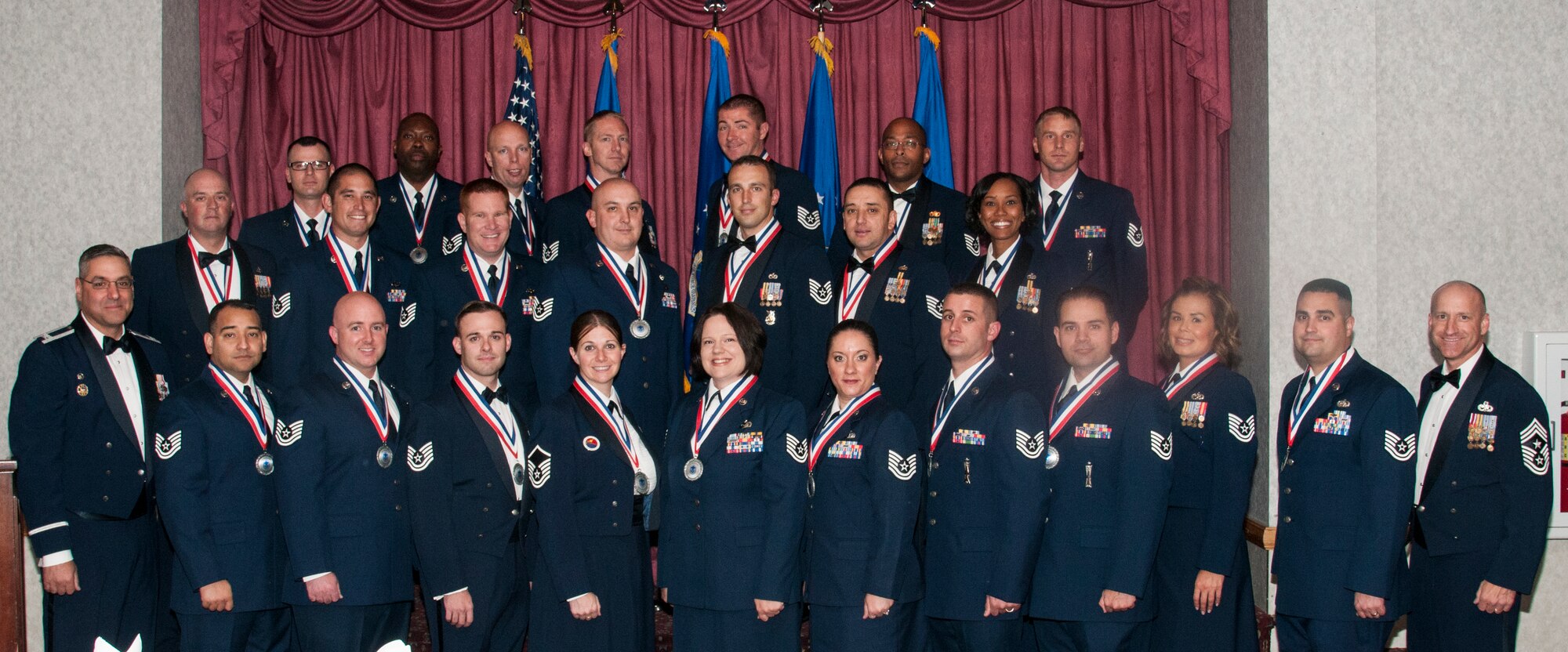 Col. Stephen Kravitsky, 90th Missile Wing commander, and Chief Master Sgt. Samuel Couch, 90th MW command chief, pose for a photo with the Mighty Ninety Airmen the wing officially welcomed to the senior non-commissioned officer corps during a ceremony in the Trail’s End Event Center on F.E. Warren Air Force Base, Wyo., Sept. 25, 2015. Some of the inductees already sewed on the rank of master sergeant, while the majority will promote over the next year. (U.S. Air Force photo by Senior Airman Jason Wiese)