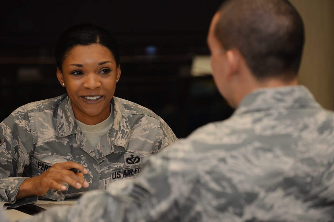 Staff Sgt. Lawanda Perthel, 28th Civil Engineer Squadron construction inspector, speaks with Senior Airman Ivan Constante, 28th Maintenance Squadron aerospace ground equipment technician, during the “Adopt an Airman” event at the Raider Café at Ellsworth Air Force Base, S.D., Sept. 17, 2015. Adopt an Airman is a two-part mentoring program designed to connect Airmen with NCOs who are subject matter experts on select programs. (U.S. Air Force photo by Senior Airman Rebecca Imwalle/Released)