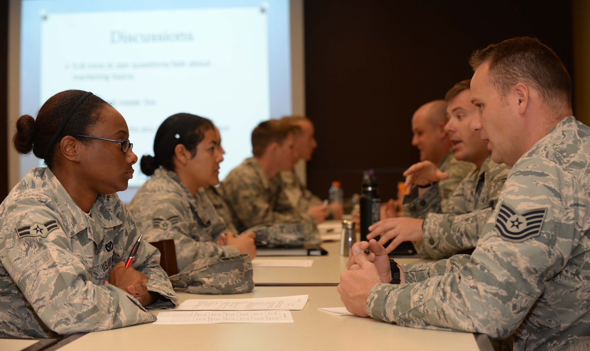 Airman 1st Class Janay Jones, 28th Civil Engineer Squadron engineering technician, (left) speaks with Tech. Sgt. Shaun Cecil, 28th Contracting Squadron NCO in charge of construction flight during a mentoring program, “Adopt an Airman,” at the Raider Café at Ellsworth Air Force Base, S.D., Sept. 17, 2015. More than 20 Airmen from around base gathered for the first session of the new mentoring program designed to connect Airmen with NCOs who are subject matter experts on select programs.  (U.S. Air Force photo by Senior Airman Rebecca Imwalle/Released)