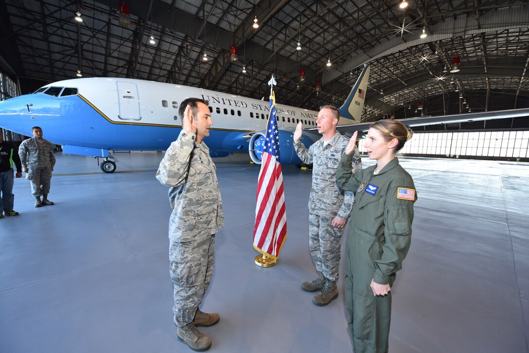 Lt. Col. Troy Appel performs the oath of enlistment again with Staff Sgt. Marie Carroll, 932nd Aeromedical Evacuation Squadron medical technician, and her brother Senior Airman Damien Ford from the 932nd Maintenance Squadron inside Hangar 1 at Scott Air Force Base, Illinois.  The siblings were choosing to continue on in the Air Force Reserve and were also interviewed as part of a video highlighting family members assigned to the 932nd Airlift Wing. To view the full video, check us out on Facebook at www.facebook.com/932ndAirliftWing or YouTube at https://www.youtube.com/user/932ndAW. (U.S. Air Force photo by Christopher Parr)