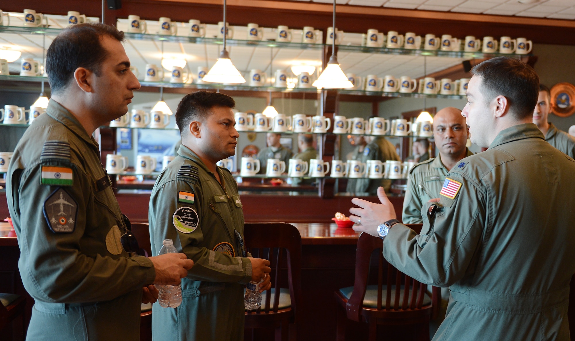 Lt. Col. Anthony Gurrieri (right), 8th Airlift Squadron deputy officer, speaks with Indian Air Force pilots Sept. 23, 2015 at Joint Base Lewis-McChord, Wash. Gurrieri and the pilots talked about the similarities and differences in approach they take when preparing for missions.  (U.S. Air Force photo/Senior Airman Divine Cox)