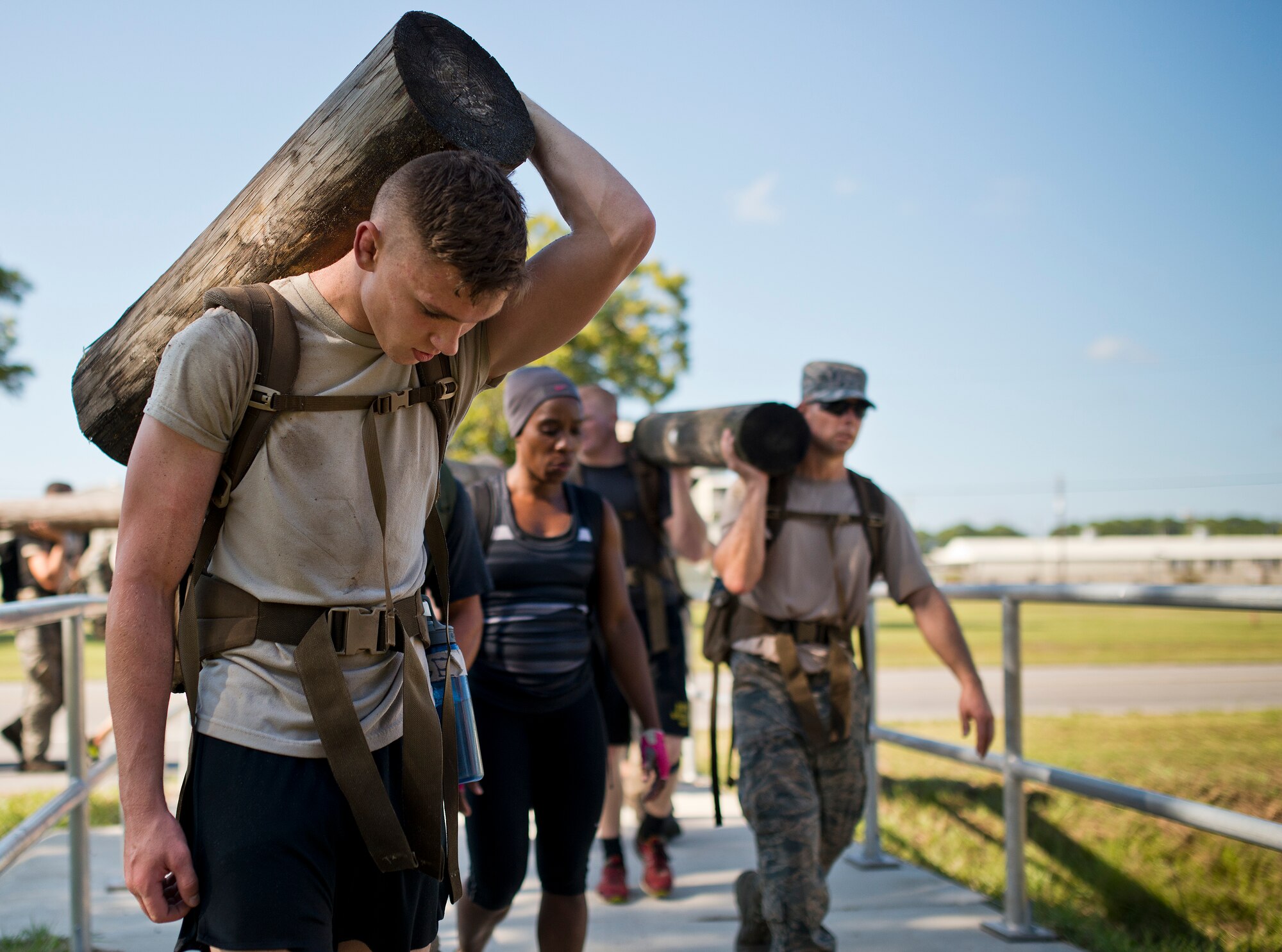 Airman Jackson Judge, 366th Training Squadron Det. 3, carries a wooden log by himself during the GoRuck team building challenge Sept. 24 at Eglin Air Force Base, Fla.  More than 45 participants pushed themselves through the physical scenarios led by a Special Forces veteran, to earn the blue and black “GoRuck” patch.  (U.S. Air Force photo/Samuel King Jr.)