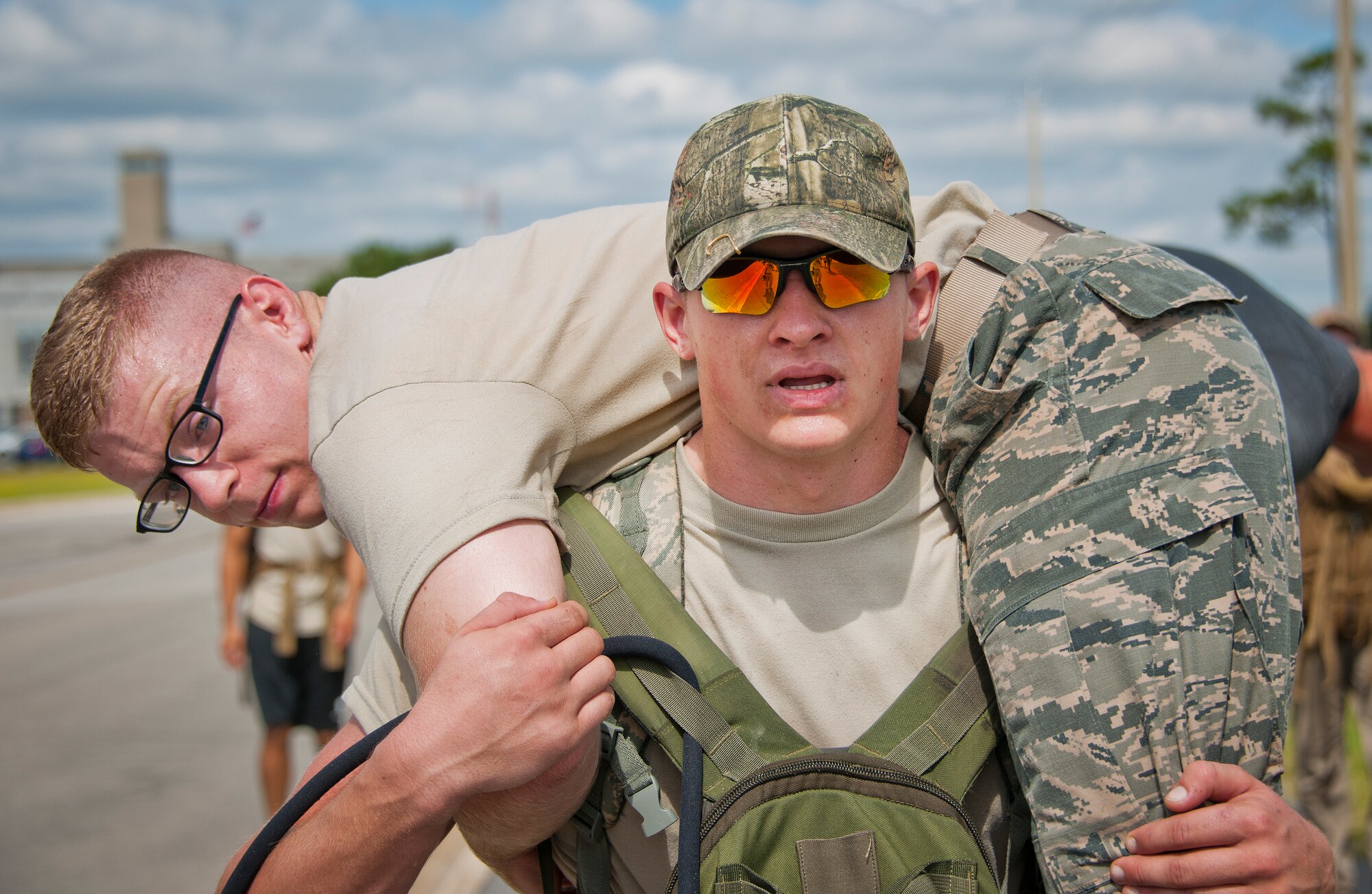 Airman Ryan Parker carries his wingman, Airman James Boglivi, 366th Training Squadron Det. 3, on his back during the GoRuck team building challenge Sept. 24 at Eglin Air Force Base, Fla.  More than 45 participants pushed themselves through the physical scenarios led by a Special Forces veteran, to earn the blue and black “GoRuck” patch.  (U.S. Air Force photo/Samuel King Jr.)
