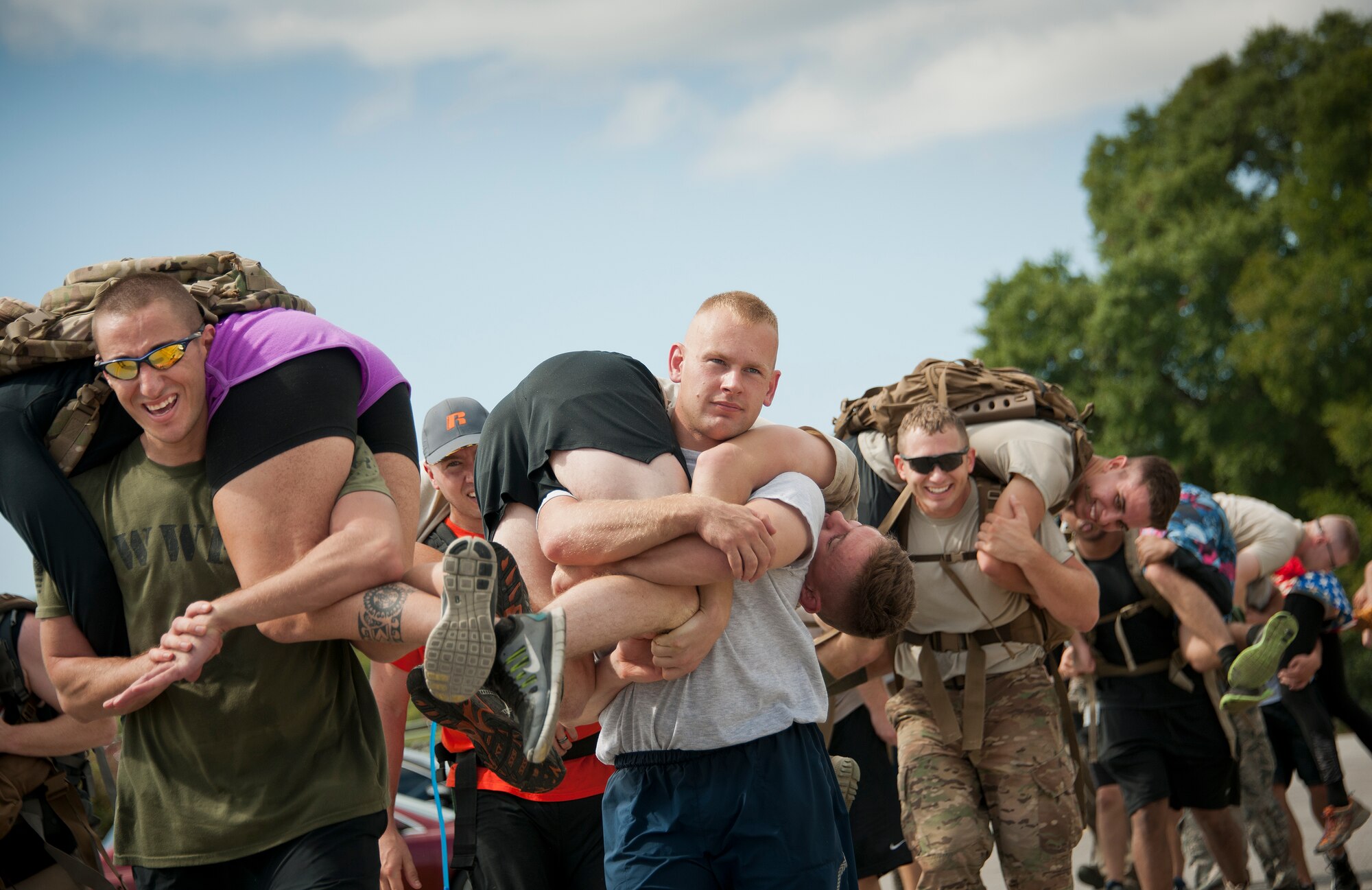 Tech. Sgt. Shane Zugai, 96th Security Forces Squadron, leads a group of participants carrying individual simulated victims during the GoRuck team building challenge Sept. 24 at Eglin Air Force Base, Fla.  More than 45 participants pushed themselves through the physical scenarios led by a Special Forces veteran, to earn the blue and black “GoRuck” patch.  (U.S. Air Force photo/Samuel King Jr.)