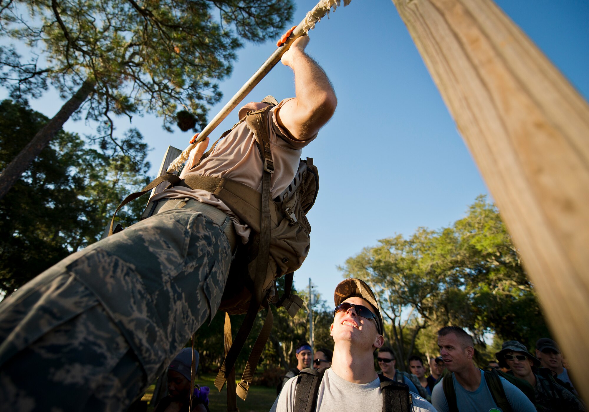 An Airman performs pull-ups at the beginning of the GoRuck team building challenge Sept. 24 at Eglin Air Force Base, Fla.  More than 45 participants pushed themselves through the physical scenarios led by a Special Forces veteran, to earn the blue and black “GoRuck” patch.  (U.S. Air Force photo/Samuel King Jr.)